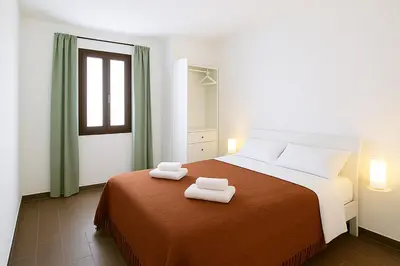 a bedroom with a bed with two towels on it at Casetta di Giulio in Palermo