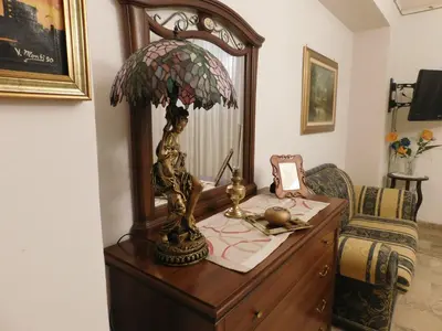 a table with a lamp on top of a dresser at Casa Emma 121 in Partinico