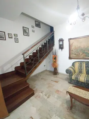 a living room with a staircase and a couch at Casa Emma 121 in Partinico