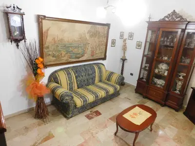 a living room with a couch and a table at Casa Emma 121 in Partinico