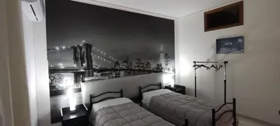 a bedroom with two beds in a room at Casa Emma 121 in Partinico