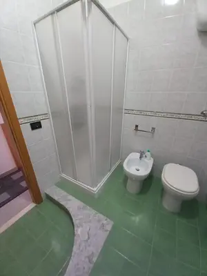 a bathroom with a shower and a toilet and a sink at GiRosa House in Bagheria