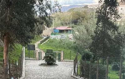 a walkway with a fence and a building in the background at Stunning Apartment In Balestrate in Balestrate