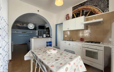 a kitchen with a table with a table cloth on it at Stunning Apartment In Balestrate in Balestrate