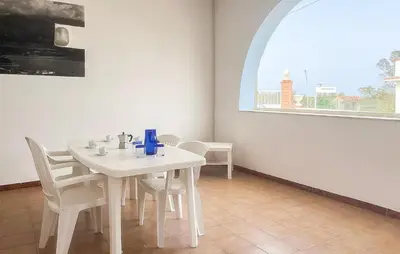 a white table and chairs in a room with a window at Stunning Apartment In Balestrate in Balestrate