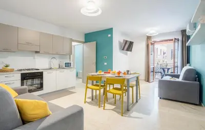 a kitchen and living room with a table and chairs at 1 Bedroom Cozy Apartment In Balestrate in Balestrate