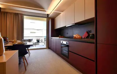 a kitchen with red cabinets and a table and a window at 5 Bedroom Stunning Apartment In Trappeto in Trappeto