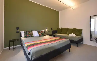 a bedroom with a bed and a couch at 5 Bedroom Stunning Apartment In Trappeto in Trappeto