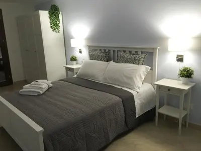 a bedroom with a large bed with two night stands at Casa Turchese Unmarediblu in San Vito lo Capo