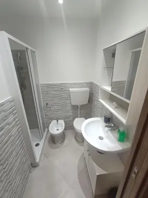 a bathroom with a toilet and a sink and a shower at Central apartment with charm for 1 or 2 people - Casa Vacanze Luna in Lascari