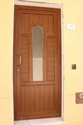 a wooden door with a mirror on it at Central apartment with charm for 1 or 2 people - Casa Vacanze Luna in Lascari