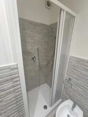 a bathroom with a shower and a sink at Central apartment with charm for 1 or 2 people - Casa Vacanze Luna in Lascari