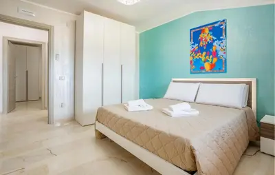 a bedroom with a bed with a blue wall at Beautiful Apartment In Balestrate in Balestrate