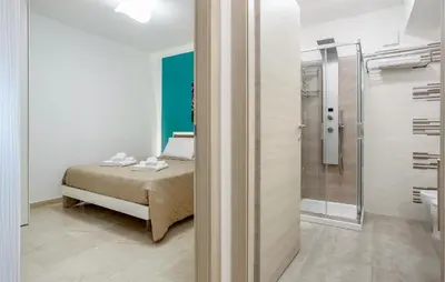 a bedroom with a bed and a glass shower at Beautiful Apartment In Balestrate in Balestrate