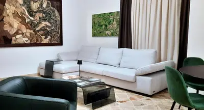 a living room with a white couch and a table at Casa d'artista Max Serradifalco in Palermo