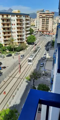 a view of a city street with buses and cars at Casa d'artista Max Serradifalco in Palermo