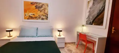 a small bedroom with a bed and a desk at Casa d'artista Max Serradifalco in Palermo