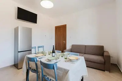 a living room with a table and a couch at Villa con Piscina in Balestrate