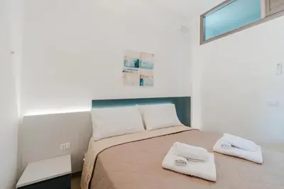 a bedroom with a bed with two white towels on it at Villa con Piscina in Balestrate
