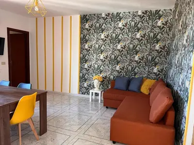 a living room with a couch and a table at Casa Mortillaro - The Heart of Palermo, Ballaro Market in Palermo