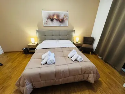 a bedroom with a bed with two towels on it at Pindemonte Pomelia in Palermo
