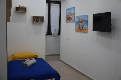 a room with a bed and a flat screen tv at Sweet dreams AF in Palermo