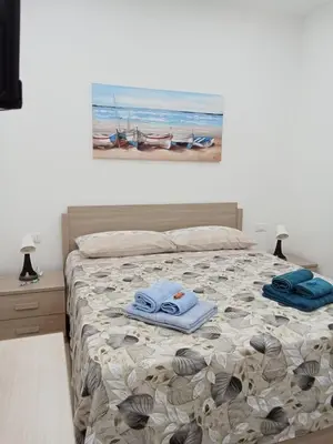 a bedroom with a bed with towels on it at Sweet dreams AF in Palermo