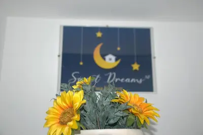 a bouquet of sunflowers in a vase next to a picture at Sweet dreams AF in Palermo