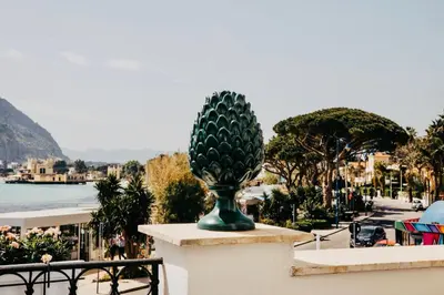 a statue of a pineapple on the side of a wall at beach front bliss mondello in Palermo