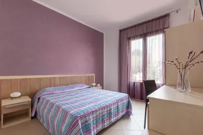 a bedroom with a bed and a window at Bed&Breakfast Acasamia in Castelluzzo