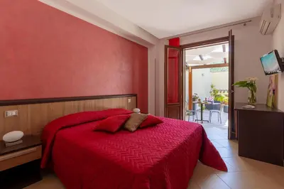 a red bedroom with a bed with a red wall at Bed&Breakfast Acasamia in Castelluzzo