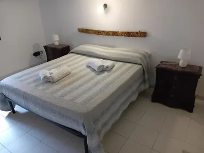 a bedroom with a bed with towels on it at Capo in Palermo