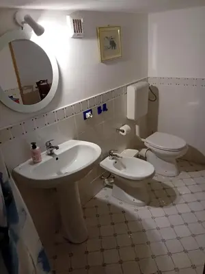 a bathroom with a sink and a toilet and a mirror at Capo in Palermo