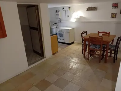 a kitchen and dining room with a table and chairs at Capo in Palermo