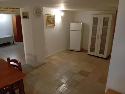 an empty room with a refrigerator and a table at Capo in Palermo