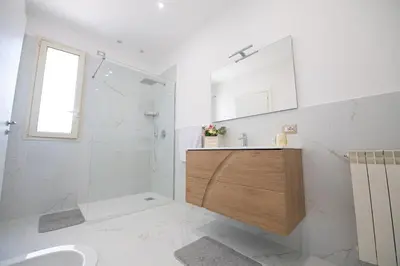 a bathroom with a shower and a sink and a toilet at From Flori in Terrasini