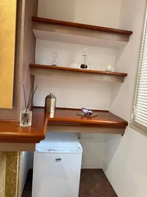 a kitchen with a wooden counter and a white refrigerator at From Flori in Terrasini