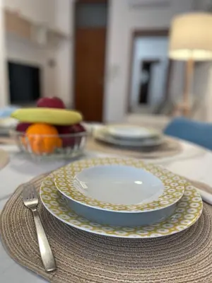 a table with a plate and a fork and knife at CasaPA-Appartamento a due passi dal Teatro Massimo in Palermo