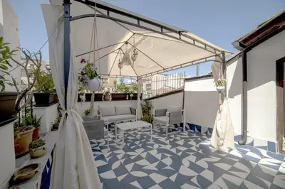 a patio with a white tent on a roof at Adenzia Suite in Palermo