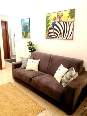 a brown couch sitting in a living room at Quattro Canti Valù in Palermo