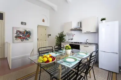 a kitchen with a table with a bowl of fruit on it at Dimora Alla Magione in Palermo