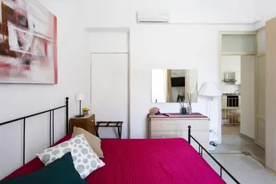 a bedroom with a bed and a dresser in a room at Dimora Alla Magione in Palermo