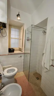 a bathroom with a toilet and a glass shower at Dimora Alla Magione in Palermo