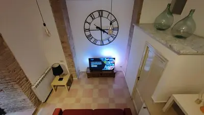 a living room with a large clock on the wall at Dimora Alla Magione in Palermo