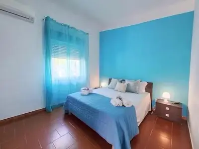 a bedroom with a bed with two towels on it at Holiday Home Green Paradise in Palermo