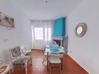 a dining room with a table and chairs and a fireplace at Holiday Home Green Paradise in Palermo