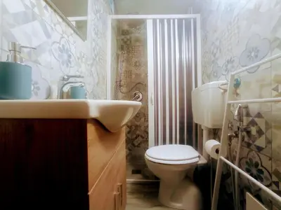 a bathroom with a sink and a toilet at La casetta di John in Palermo