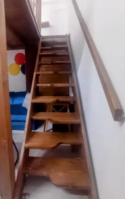 a staircase with wooden steps in a room at La casetta di John in Palermo