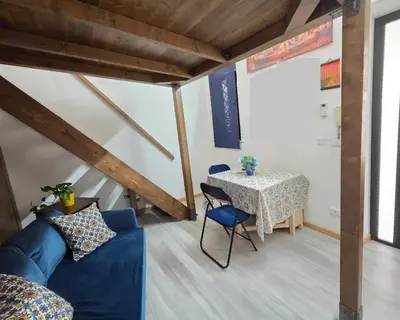 a living room with a blue couch and a table at La casetta di John in Palermo