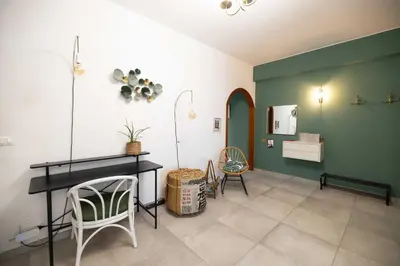 a living room with a table and some chairs at Nest - Family House in Santa Flavia
